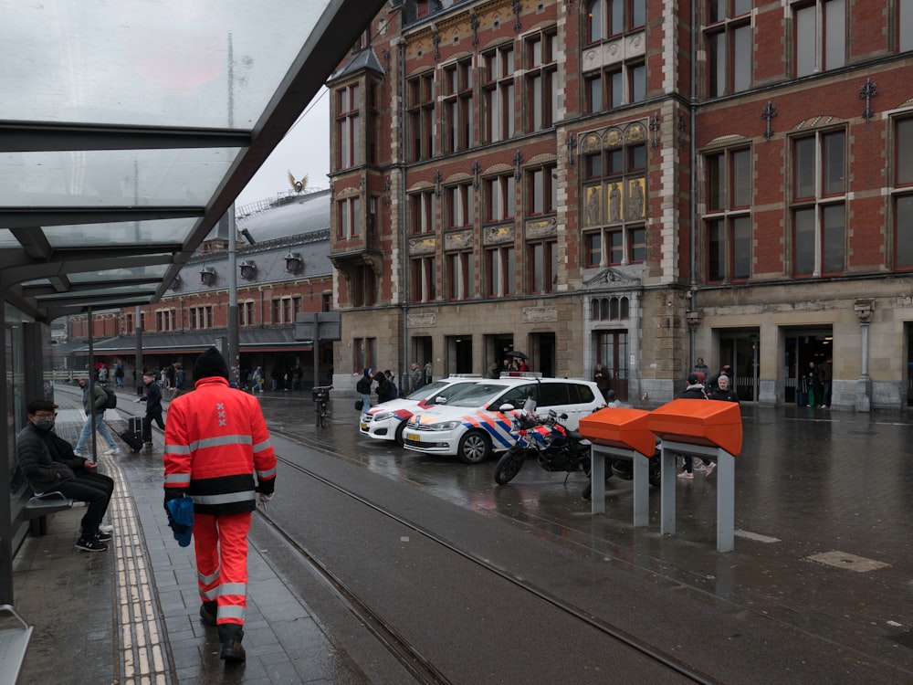 Un homme marchant dans une rue à côté de grands immeubles