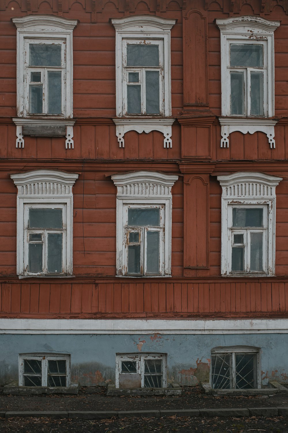 a red building with white windows and a clock