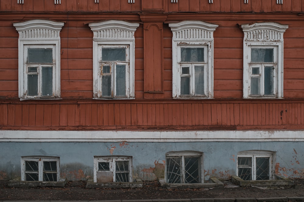 an old building with windows and a stop sign in front of it