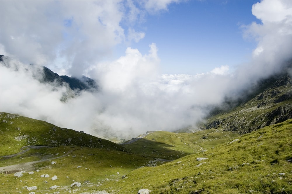 a view of a mountain range with low lying clouds