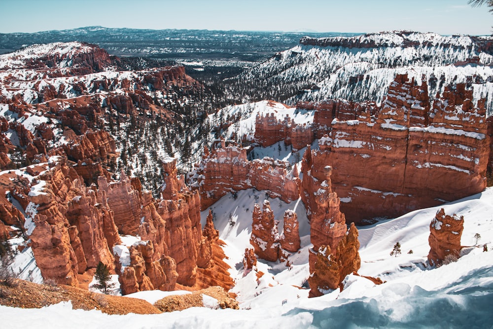 a view of a snow covered canyon with a mountain in the background