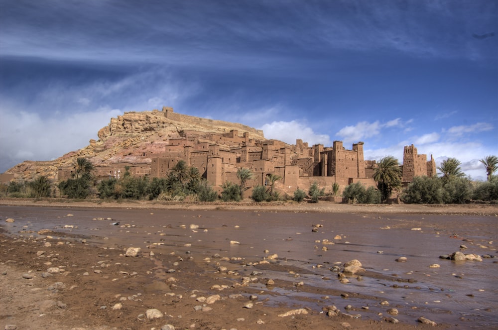 a large brown building sitting on top of a hill