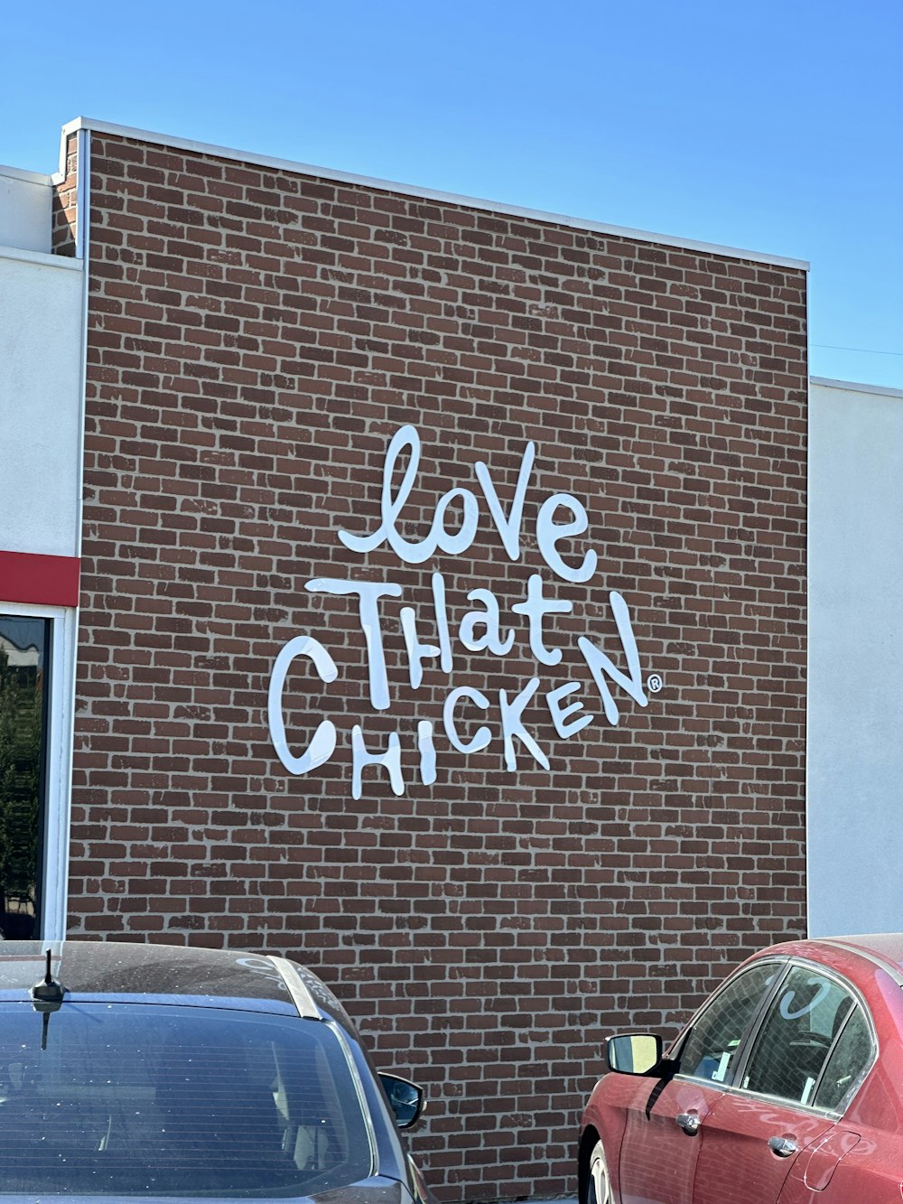 a brick building with graffiti written on it