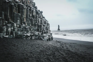 A breathtaking view of Reynisfjara’s black sand beach with basalt columns.