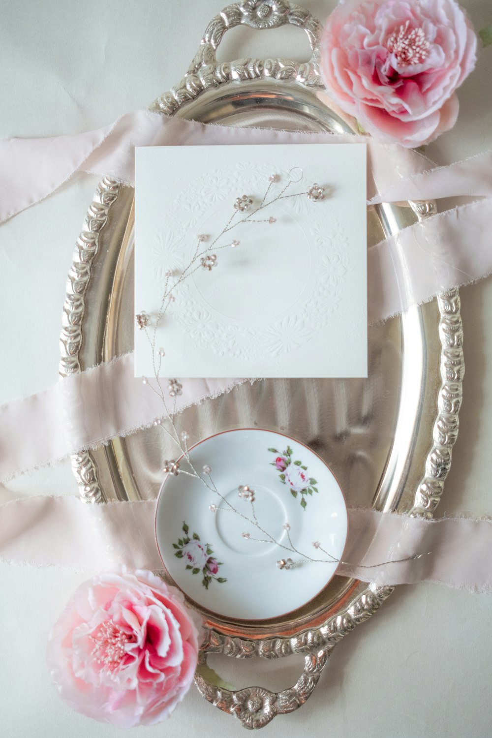 a plate with a card and some flowers on it