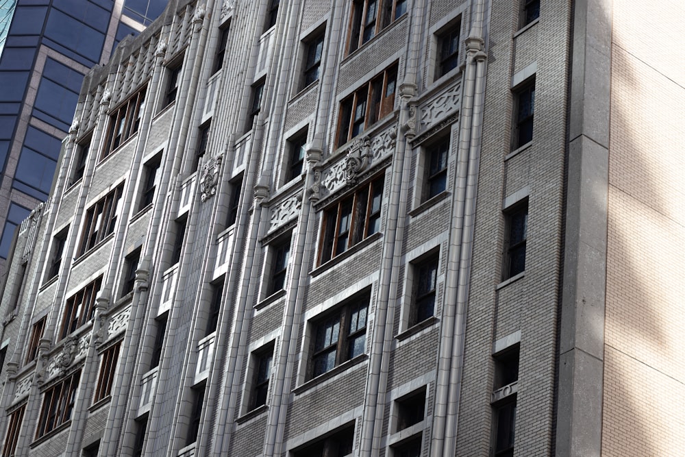 a tall building with lots of windows next to a tall building