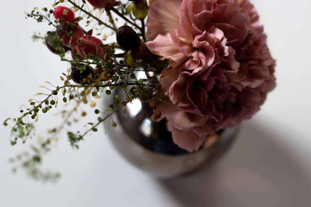 a close up of a vase with flowers in it