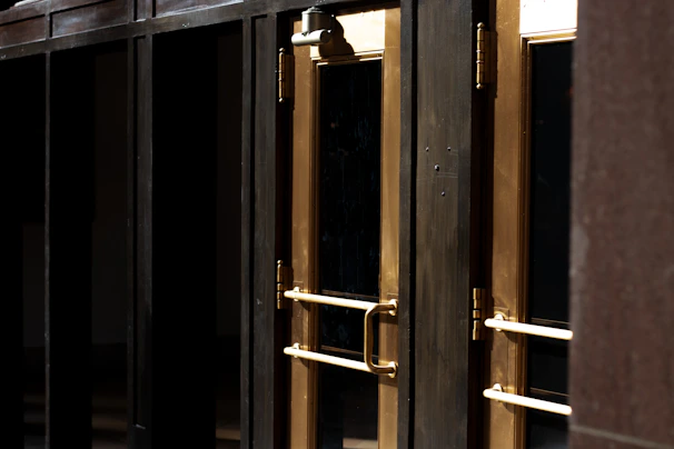 A row of various forged doors displayed in a bright showroom setting