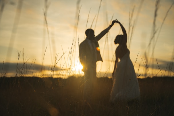 A wide shot of a sunset backdrop framing the newlyweds' first dance.
