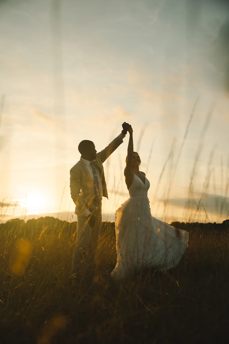 Bride and groom dancing at sunset