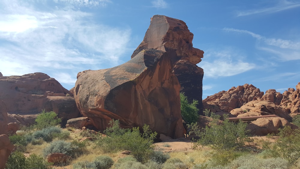 a large rock in the middle of a desert