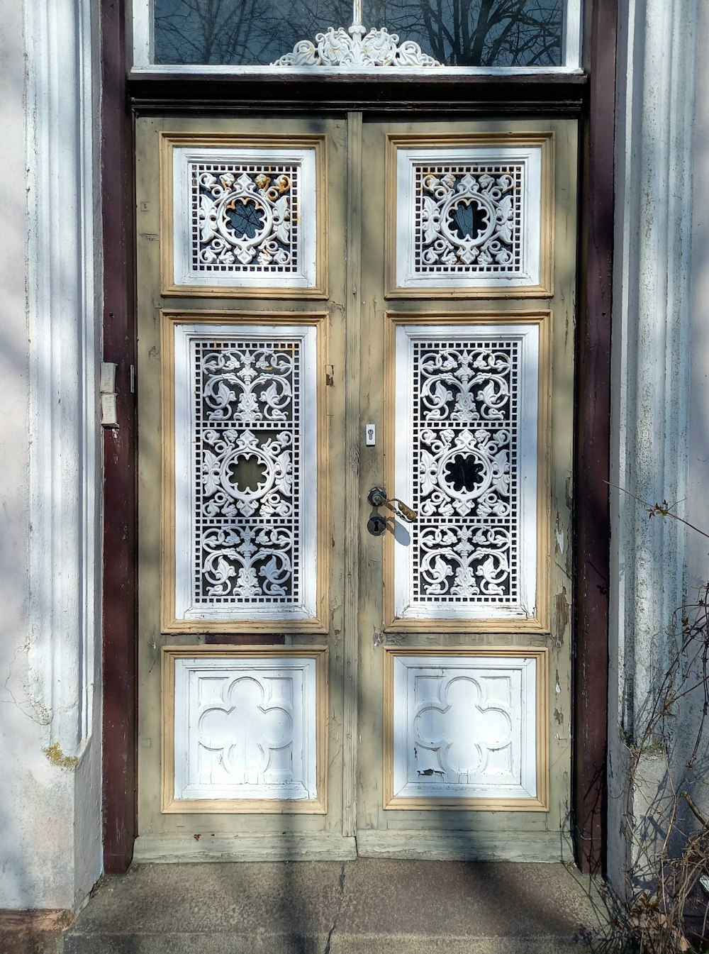 a large wooden door with a cross on top of it