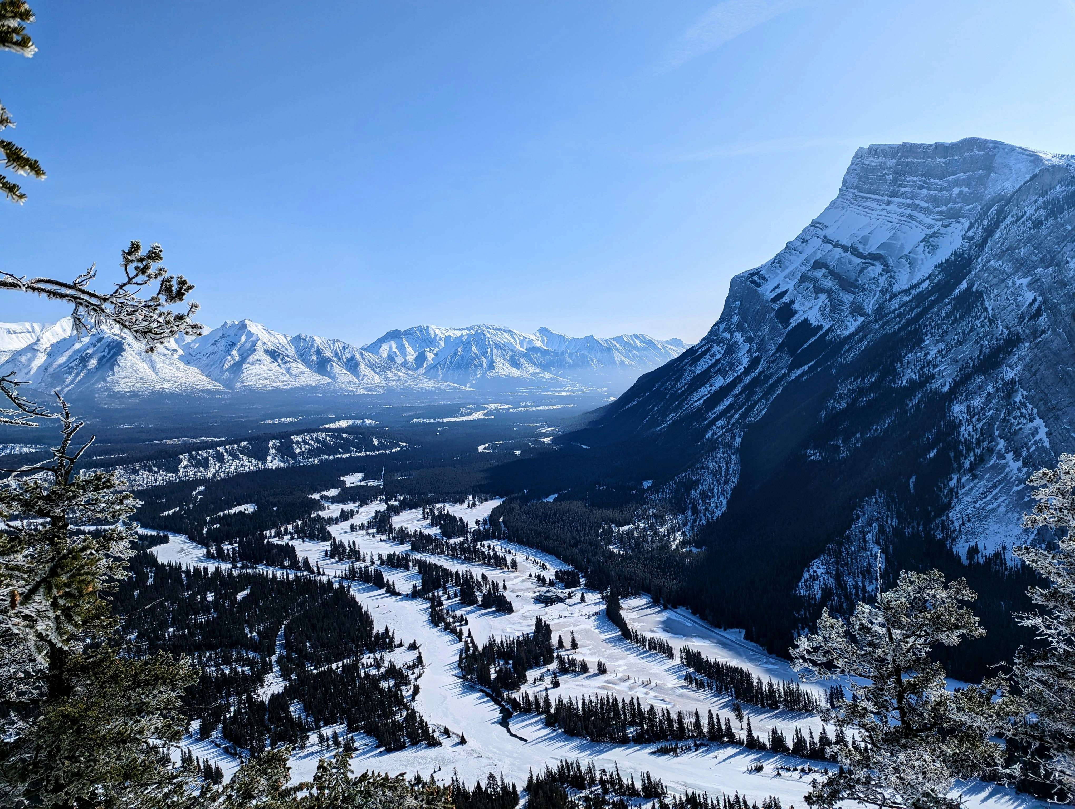 a view of a snowy mountain range with a river running through it, 