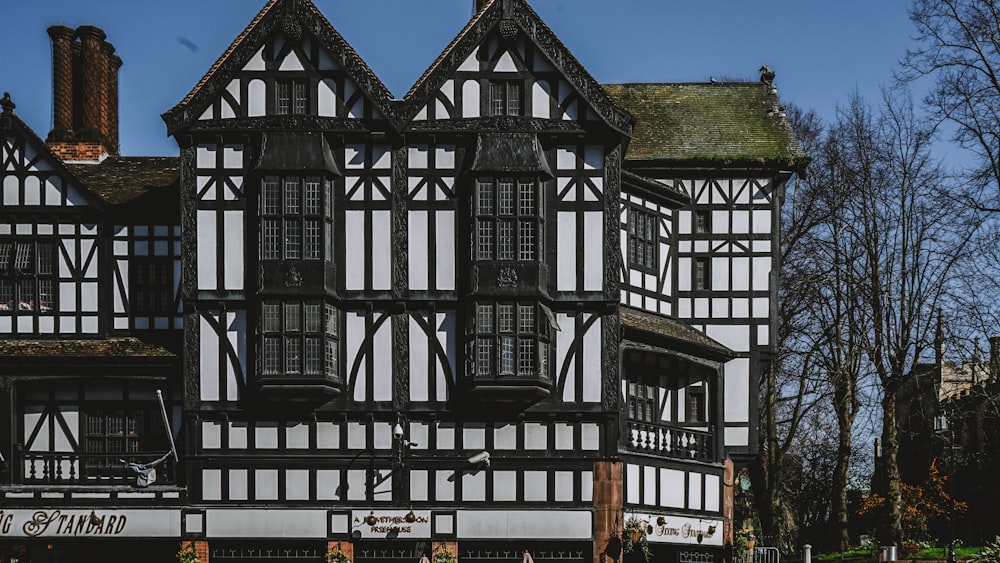 a large black and white building with lots of windows