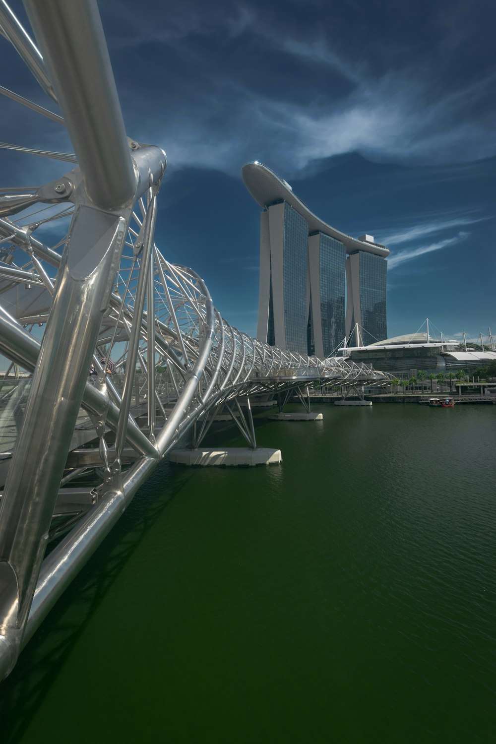 a bridge over a body of water with tall buildings in the background