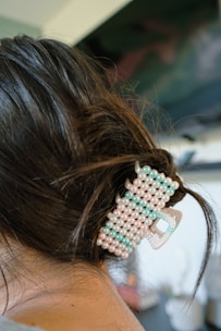 a close up of a person with a hair clip in their hair