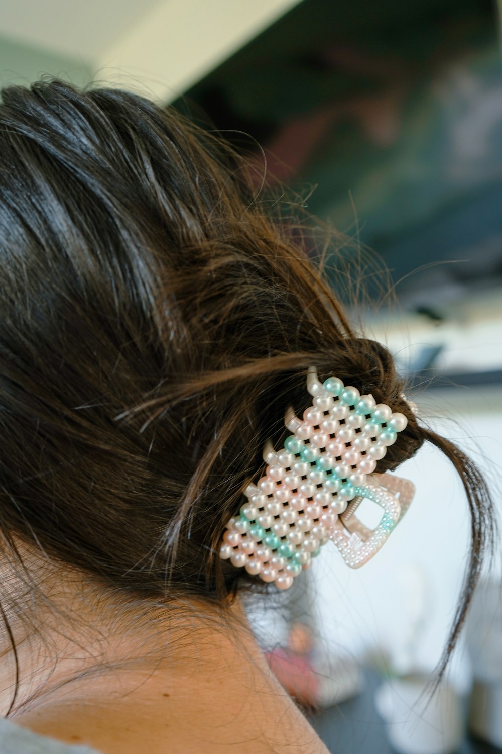 a close up of a person with a hair clip in their hair