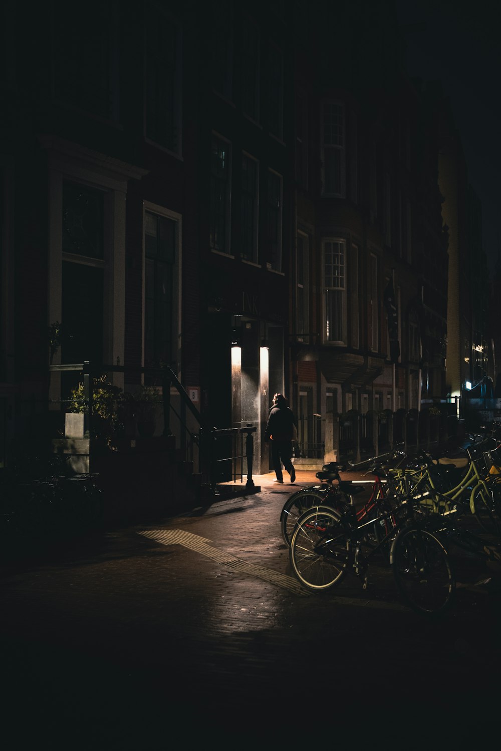 a man standing in the doorway of a building at night