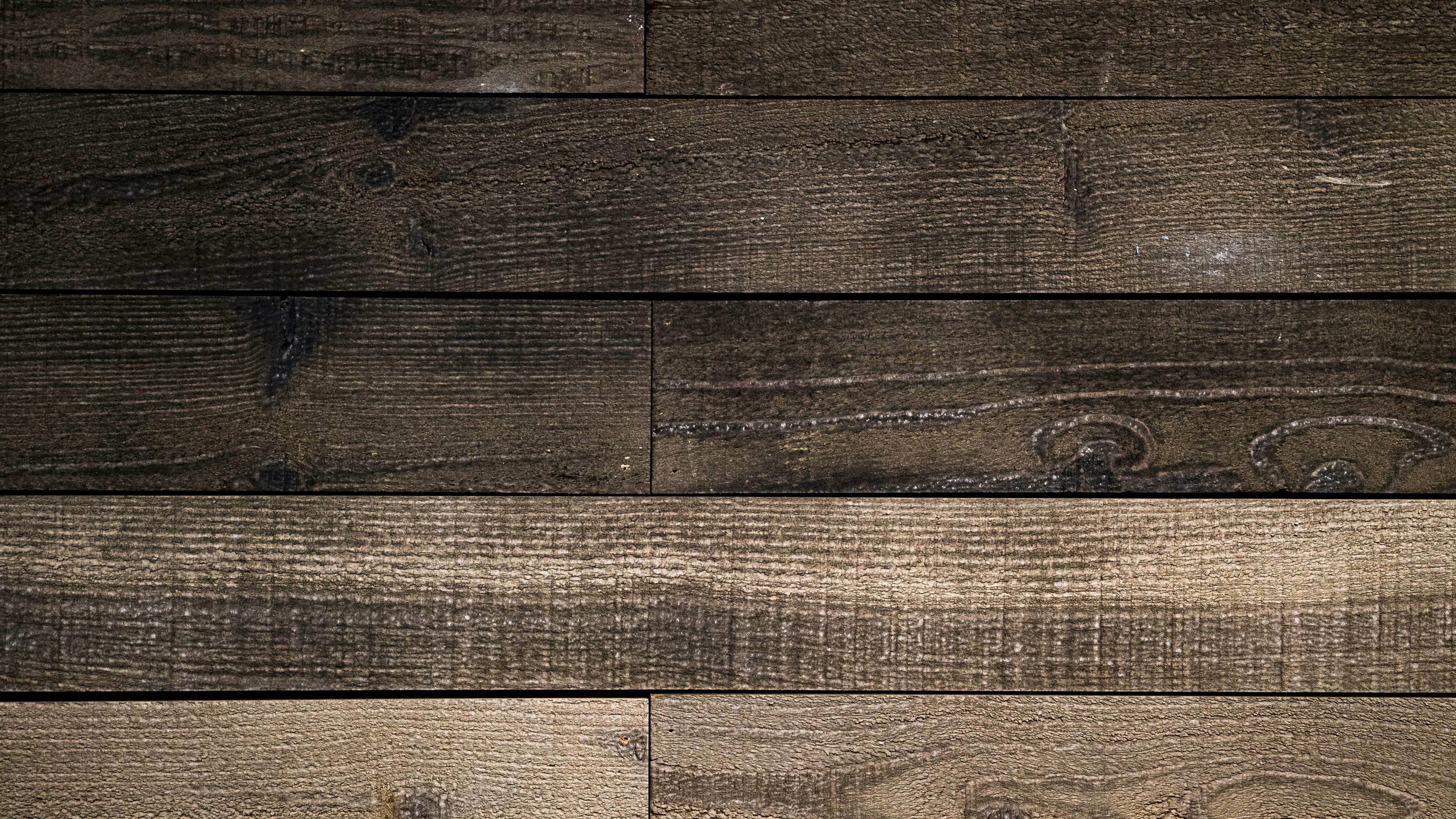 a close up of a wooden wall with a clock on it