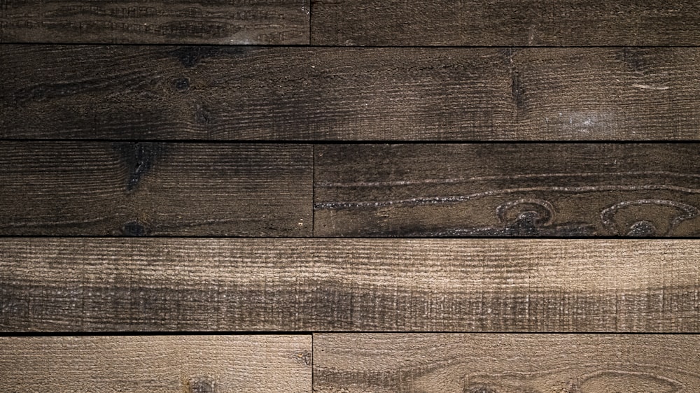 a close up of a wooden wall with a clock on it