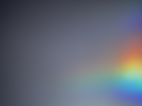 A gradient gray background with a soft, semi-transparent rainbow appearing primarily on the right side, blending smoothly into the surrounding area.