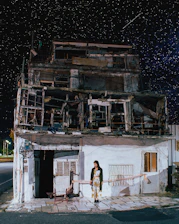 A confident woman standing beneath a starry sky, symbolizing guidance and new financial horizons.