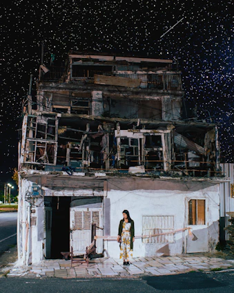 A confident woman standing beneath a starry sky, symbolizing guidance and new financial horizons.