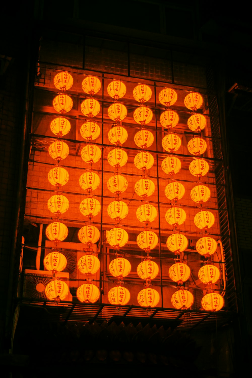 a bunch of lit up orange lights in the dark