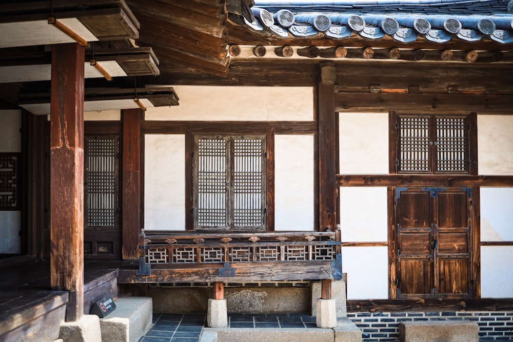 a wooden bench sitting in front of a building