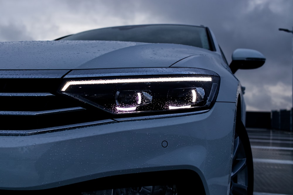 a close up of a car's headlights on a cloudy day