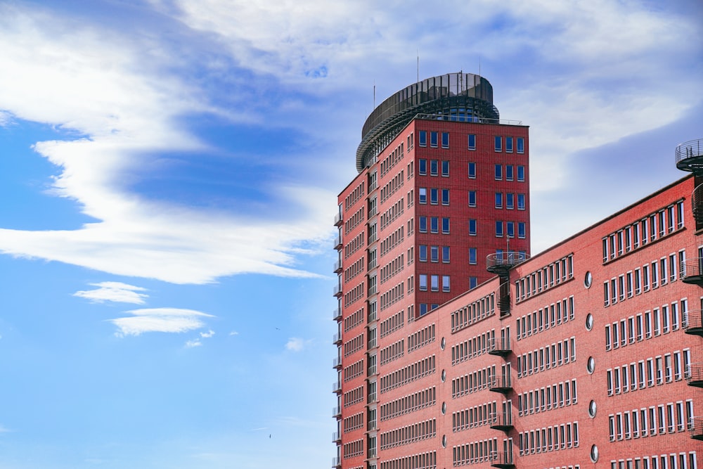 a tall red building sitting next to a tall red building