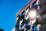 A freshly cleaned apartment building exterior with sparkling windows under a bright blue sky.