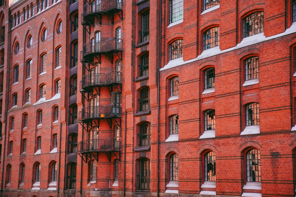 a row of red brick buildings with balconies
