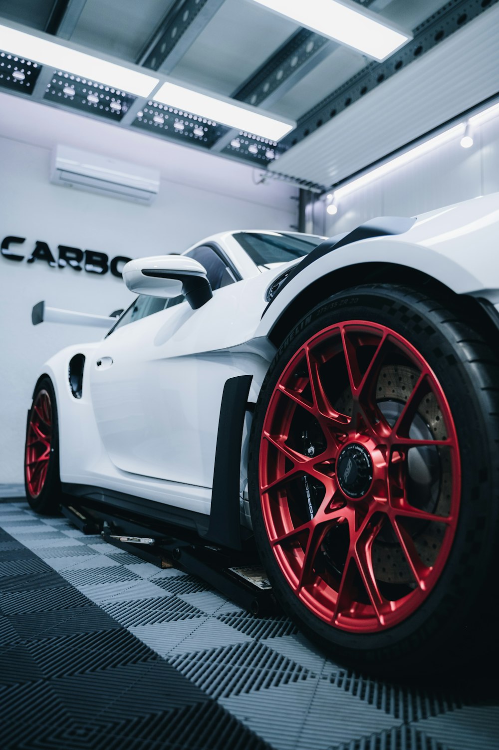 a white sports car parked in a garage