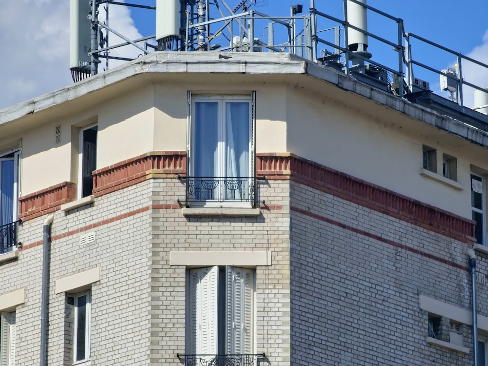 a tall brick building with a metal balcony