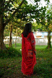 Model gracefully draped in a lightweight cotton saree, walking through a serene garden