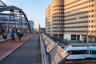 a train traveling down tracks next to tall buildings
