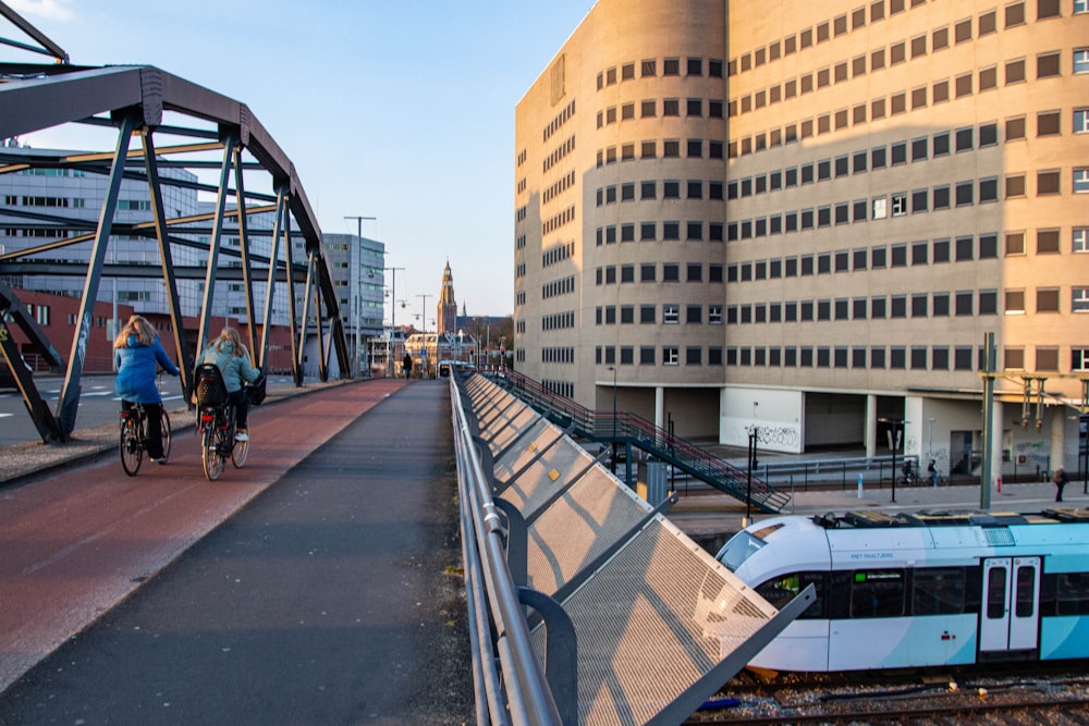 a train traveling down tracks next to tall buildings