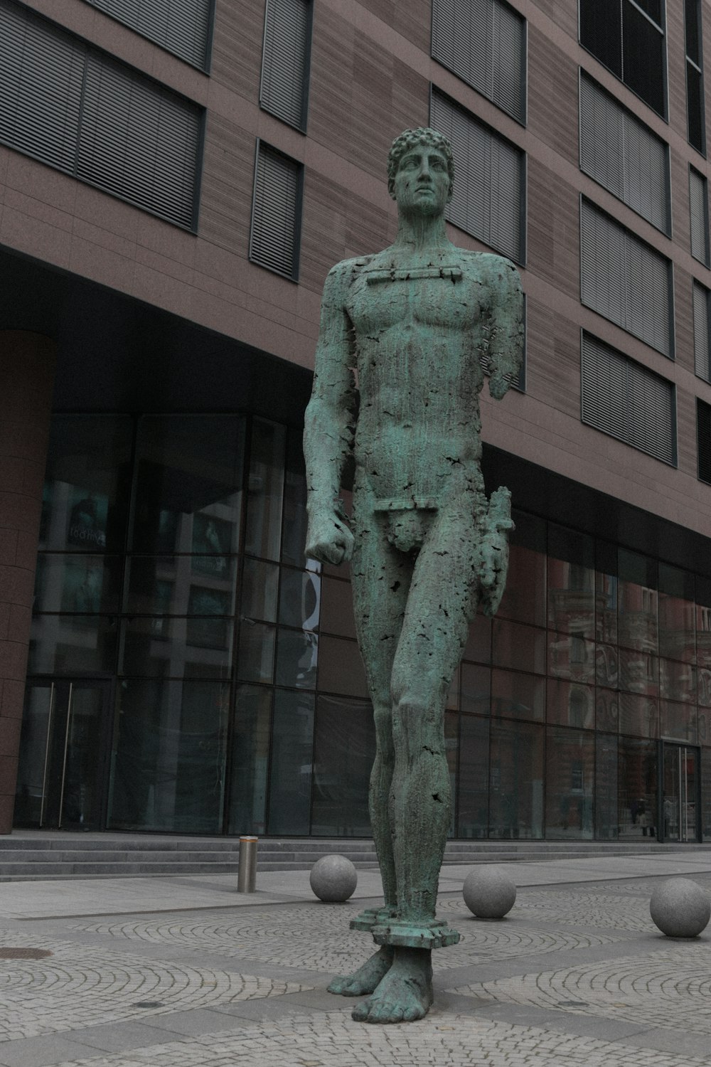 a statue of a man standing in front of a building