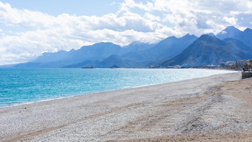 a view of a beach with mountains in the background