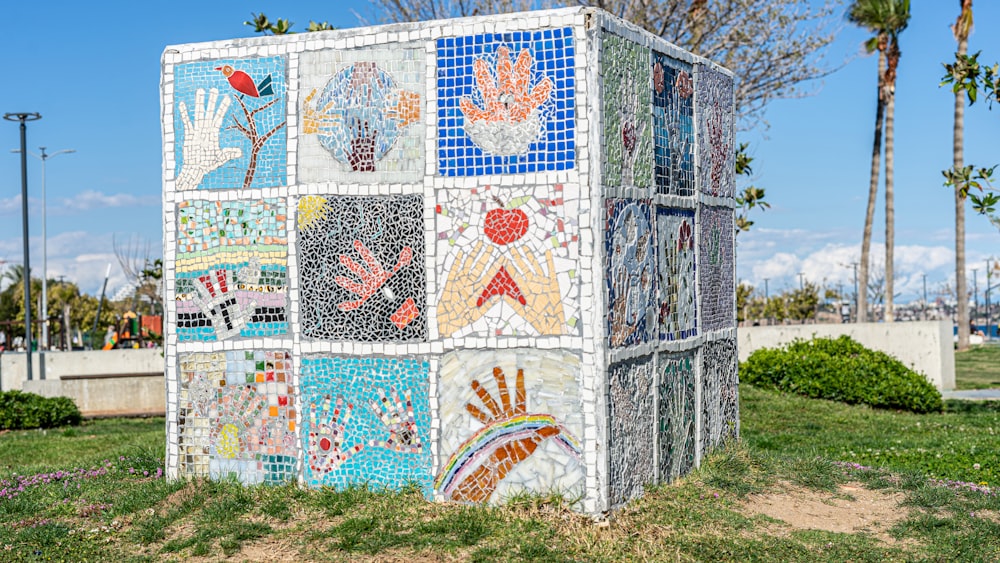 a sculpture made out of mosaic tiles in a park