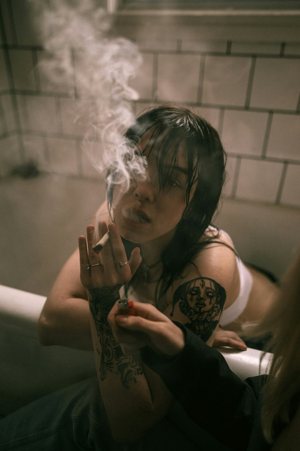 a woman smoking a cigarette in a bathroom