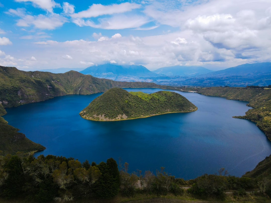 a large body of water surrounded by mountains,