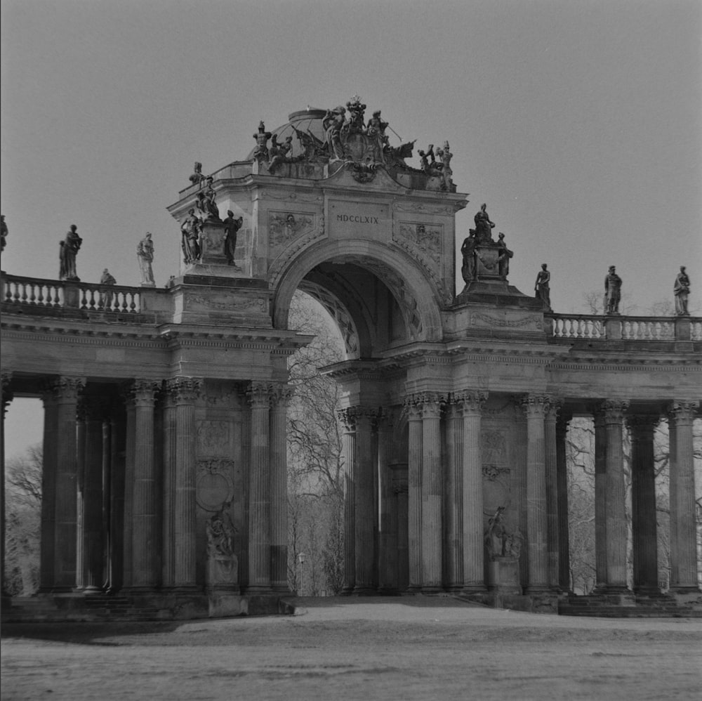 a black and white photo of a large arch