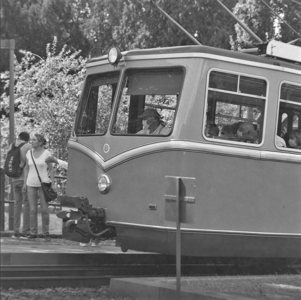 a black and white photo of a trolley car