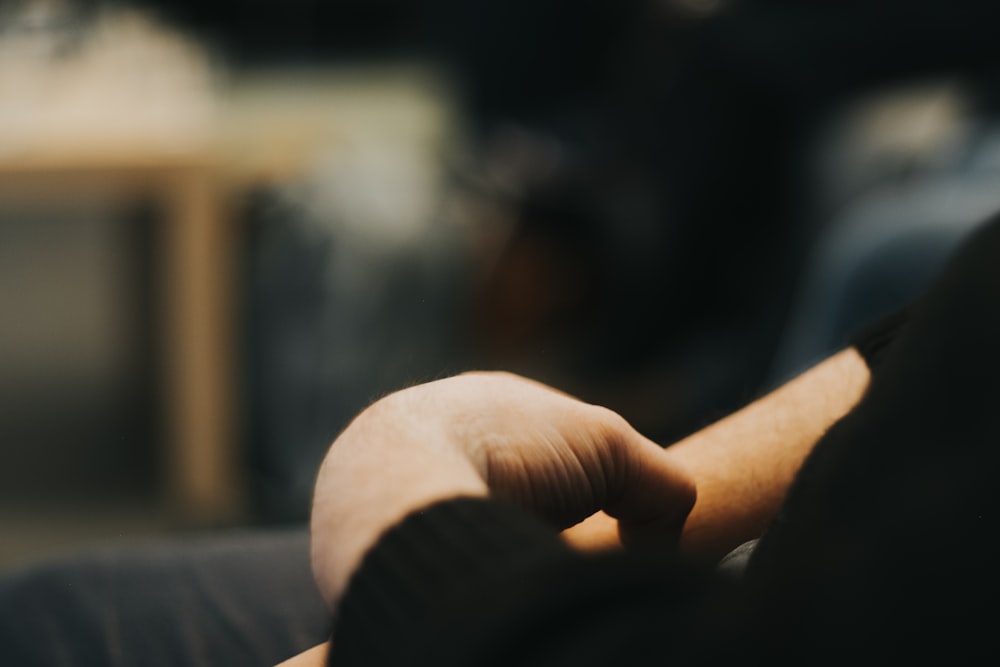 a close up of a person's hand with a blurry background