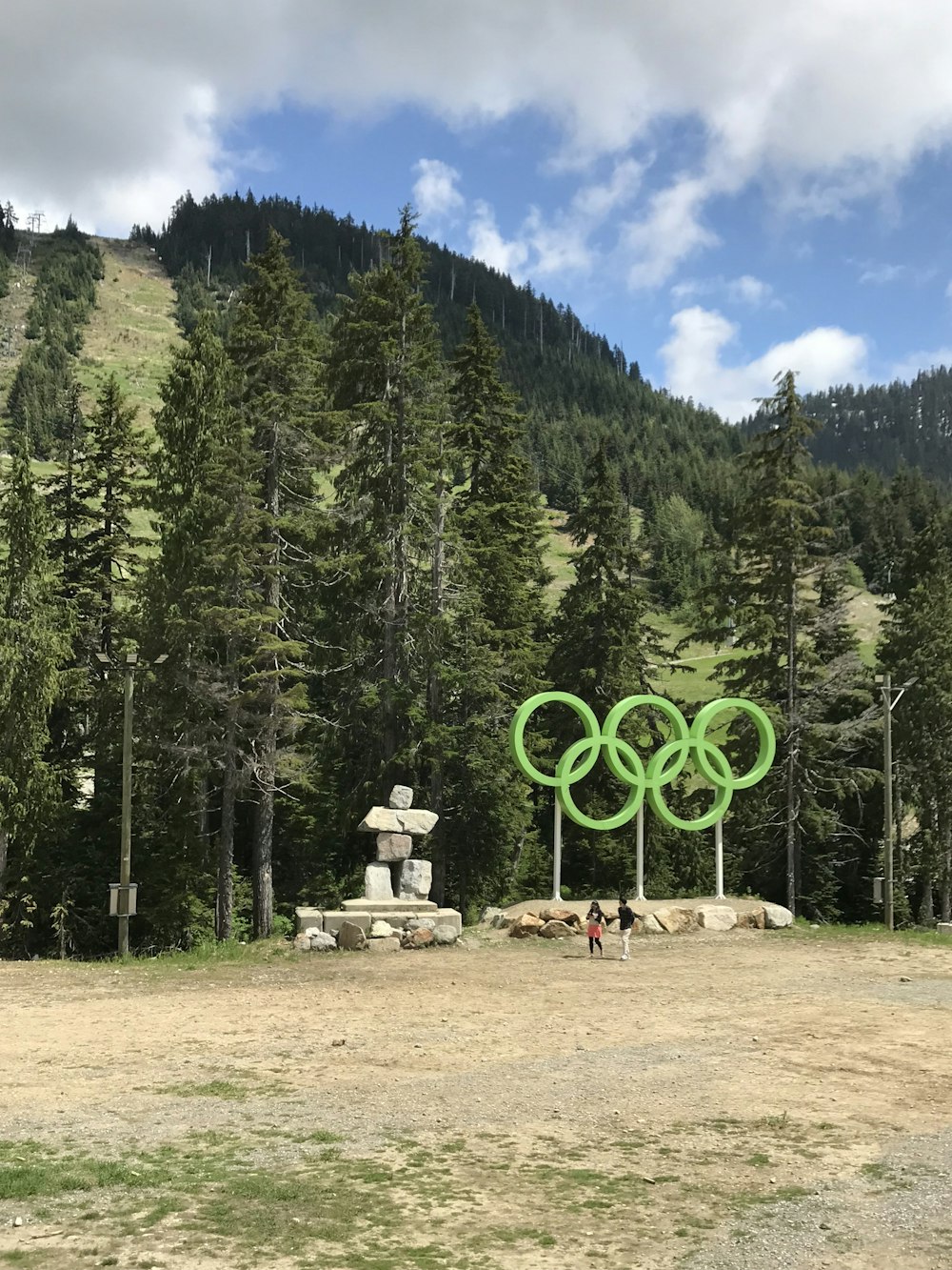 a couple of people standing in front of a large sculpture