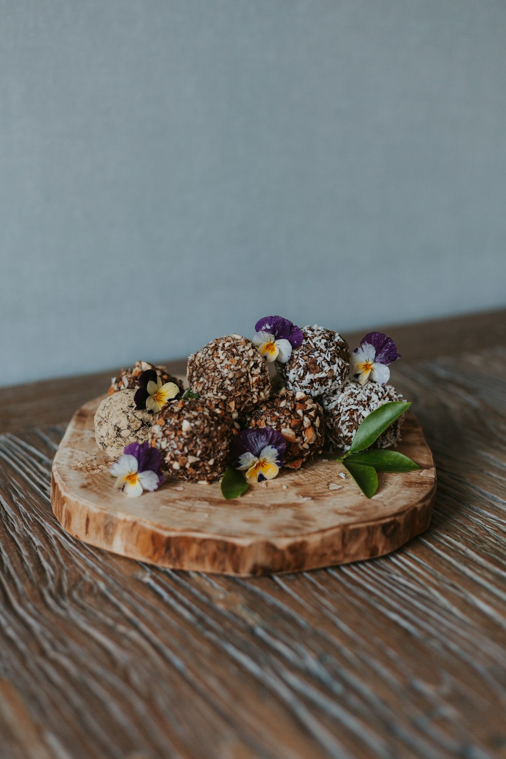 a wooden board topped with a pile of fruit