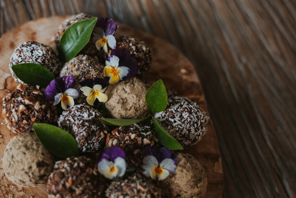 a plate of chocolates with flowers on top of it