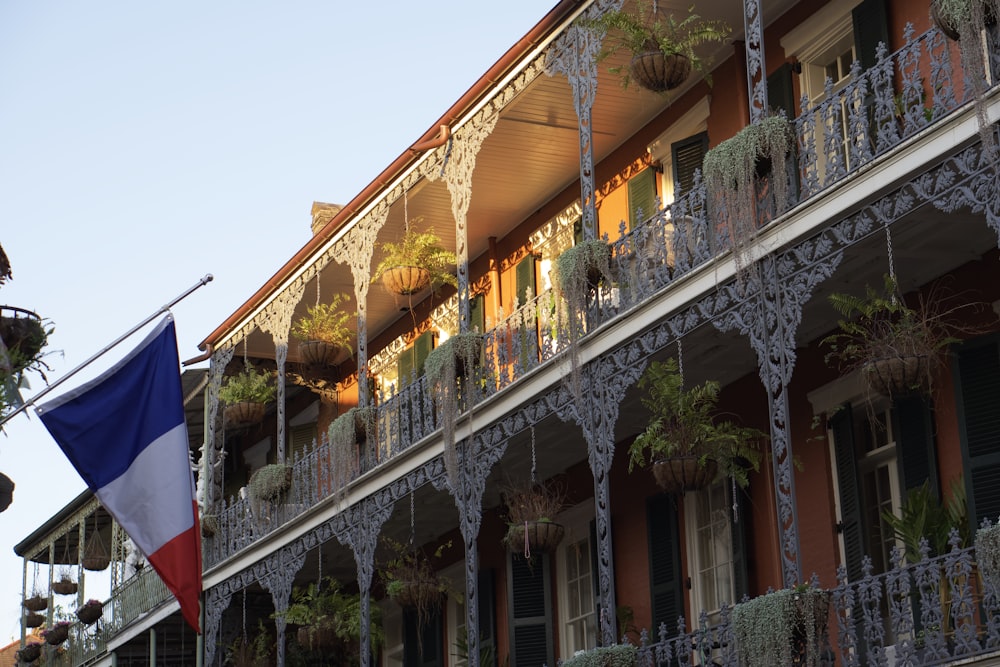 a building with a flag hanging from it's balconies